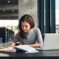 femalestudentstudyingatcollegelibrarypdarkw9